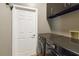 Modern laundry room with gray walls, built-in cabinets and stainless steel washer and dryer at 824 Palm Cove Dr, Orlando, FL 32835