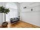 Bright living room featuring hardwood floors, gray sofa, and lots of natural light from the large window at 824 Palm Cove Dr, Orlando, FL 32835