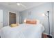 Bedroom with a queen-sized bed, wood floors, ceiling fan, and walk-in closet at 8711 Rockingham Ter # A, Kissimmee, FL 34747