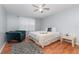 Bright bedroom featuring a ceiling fan, wood-look floors, an accent rug, and a plush blue armchair at 8711 Rockingham Ter # A, Kissimmee, FL 34747
