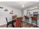 Open dining area with breakfast bar leading to kitchen with stainless steel appliances at 8711 Rockingham Ter # A, Kissimmee, FL 34747