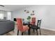 Cozy dining area featuring a glass-top table with chairs and modern shelving at 8711 Rockingham Ter # A, Kissimmee, FL 34747
