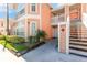 Charming condo featuring a two-story exterior with a walkway leading to the unit's entrance and a staircase at 8711 Rockingham Ter # A, Kissimmee, FL 34747