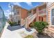 Condominium featuring peachy siding, a white banister for the stairway, and is surrounded by lush landscaping at 8711 Rockingham Ter # A, Kissimmee, FL 34747