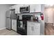 Modern kitchen featuring stainless steel appliances, granite countertops, and white cabinets at 8711 Rockingham Ter # A, Kissimmee, FL 34747