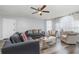 Cozy living area featuring hardwood floors, comfortable seating, and large windows offering plenty of natural light at 8711 Rockingham Ter # A, Kissimmee, FL 34747