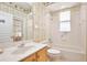 Bathroom featuring a large mirror, neutral tiling, and a tub and shower combo at 9102 Shadowbrook Trl, Orlando, FL 32825