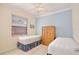 Bright bedroom with two beds, blue accent wall, and a window with a view at 9102 Shadowbrook Trl, Orlando, FL 32825