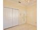 This bedroom features tiled floors, a closet and a door that leads to another room at 9102 Shadowbrook Trl, Orlando, FL 32825