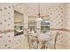Cozy breakfast nook with round table and views of the screened-in lanai and landscaped backyard at 9102 Shadowbrook Trl, Orlando, FL 32825