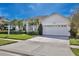 Charming single-story home featuring a well-manicured lawn and a two car garage at 9102 Shadowbrook Trl, Orlando, FL 32825
