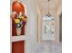 Elegant foyer with decorative niche, tiled floor, and a view of the front door and chandelier at 9102 Shadowbrook Trl, Orlando, FL 32825