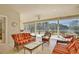 Inviting lanai with wicker furniture offers serene views of the lake at 9102 Shadowbrook Trl, Orlando, FL 32825