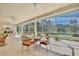 Screened-in lanai with a table setting offers scenic views at 9102 Shadowbrook Trl, Orlando, FL 32825