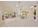 Open-concept living area features tile flooring, high ceilings, and sliding glass doors to the lanai at 9102 Shadowbrook Trl, Orlando, FL 32825