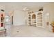 Bright and airy living room with tile flooring, built-in shelves, and elegant entryway at 9102 Shadowbrook Trl, Orlando, FL 32825