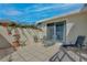 Tiled patio has seating for outdoor entertaining and a partial privacy wall with colorful bougainvillea at 9102 Shadowbrook Trl, Orlando, FL 32825