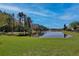 Calm pond, surrounded by lush greenery, offers serene views at 9102 Shadowbrook Trl, Orlando, FL 32825
