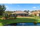 Spacious backyard with a screened lanai, overlooking a tranquil pond at 9102 Shadowbrook Trl, Orlando, FL 32825