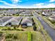 Aerial view of a neighborhood with green lawns, mature trees, and well-maintained landscaping at 937 Avery Meadows Way, Deland, FL 32724