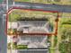 Neat property featuring a well-maintained lawn with shrubs, landscaping, and a red car parked in front at 937 Avery Meadows Way, Deland, FL 32724