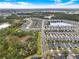 An aerial view showcases an expansive housing community surrounding a shimmering lake at 937 Avery Meadows Way, Deland, FL 32724