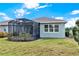 View of a backyard with a screened-in patio and a well-maintained lawn at 937 Avery Meadows Way, Deland, FL 32724