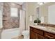 Bathroom features a shower-tub combo with lovely tile and a sink with a granite countertop at 937 Avery Meadows Way, Deland, FL 32724