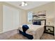 Cozy bedroom featuring shuttered windows, comfortable bed, and sliding closet doors at 937 Avery Meadows Way, Deland, FL 32724