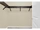 Bright walk-in closet with built in dark colored shelving and beige colored walls ready for organizing at 937 Avery Meadows Way, Deland, FL 32724