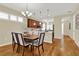 Dining area featuring a stylish chandelier and hardwood floors adjacent to the kitchen at 937 Avery Meadows Way, Deland, FL 32724
