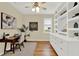 Bright home office featuring hardwood floors, custom built-in shelving, and large window at 937 Avery Meadows Way, Deland, FL 32724