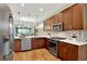Well-equipped kitchen featuring granite counters, stainless appliances, and an open layout to the living area at 937 Avery Meadows Way, Deland, FL 32724