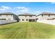 Expansive backyard between houses with a large lawn, and white fencing at 965 Talon Pl, Winter Springs, FL 32708