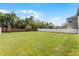 Spacious backyard featuring well-maintained lawn, surrounded by white and red brick fences at 965 Talon Pl, Winter Springs, FL 32708