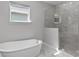 Serene bathroom featuring a soaking tub and a glass-enclosed shower, perfect for relaxation at 965 Talon Pl, Winter Springs, FL 32708