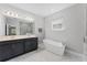 Elegant bathroom with double vanity, soaking tub, and walk-in shower, providing a spa-like experience at 965 Talon Pl, Winter Springs, FL 32708