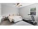 Inviting bedroom featuring a queen bed, ceiling fan, and a treadmill for exercise at 965 Talon Pl, Winter Springs, FL 32708