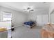 Inviting bedroom with playful decor, a ceiling fan and an exposed wood dresser at 965 Talon Pl, Winter Springs, FL 32708