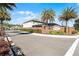 Exterior view of neighborhood entrance featuring a gate, brick walls, sign and palm trees at 965 Talon Pl, Winter Springs, FL 32708