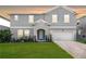Charming two-story home features a well-manicured lawn, an attached two car garage, and a welcoming front entrance at 965 Talon Pl, Winter Springs, FL 32708