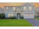Charming two-story home with a well-manicured lawn, a two-car garage, and a welcoming front entrance at 965 Talon Pl, Winter Springs, FL 32708