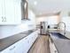 Well-lit kitchen with white cabinets, stainless steel appliances, and a modern sink, perfect for cooking and entertaining at 965 Talon Pl, Winter Springs, FL 32708