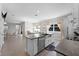 Open concept kitchen with large island, white cabinets, stainless appliances, and view to dining area at 965 Talon Pl, Winter Springs, FL 32708