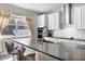 Modern kitchen featuring white cabinets, an island with seating, and stainless steel appliances at 965 Talon Pl, Winter Springs, FL 32708