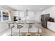 Modern kitchen featuring white cabinets, a large island with seating, and stainless steel appliances at 965 Talon Pl, Winter Springs, FL 32708