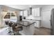 Modern kitchen featuring white cabinets, a large island with seating, and stainless steel appliances at 965 Talon Pl, Winter Springs, FL 32708