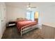 This bedroom has carpet, a ceiling fan, an accent pillow, and a door leading to the bathroom at 9787 Introduction Way, Orlando, FL 32832