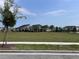 Wide shot of community green with playground and lounging areas at 9787 Introduction Way, Orlando, FL 32832