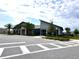 Community clubhouse with modern architecture, lush landscaping, and ample parking at 9787 Introduction Way, Orlando, FL 32832